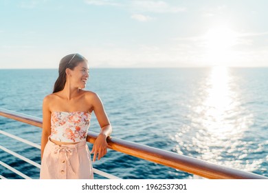 Cruise travel vacation Asian young woman looking at ocean watching sunset from balcony deck. Happy tourist lady relaxing on holidays - Powered by Shutterstock