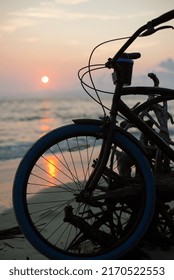 Cruiser Bicycle On Beach At Sunrise.