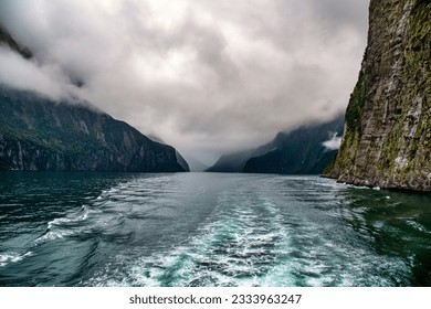 Cruising in a large catamaran past Mitre Peak and many waterfalls through the Milford Sound - Powered by Shutterstock
