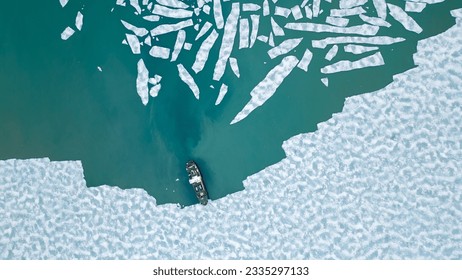 A cruising ship is anchored between pieces of ice in the arctic ocean near Svalbard. 