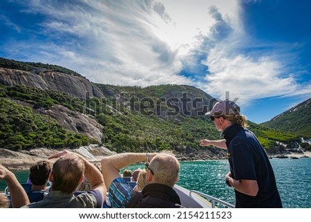 Cruising tour with people, guide tour introducing at stone rock mountain forest seascape in the Bass Strait at Wilson Promontory Victoria Australia, blue sky and blue sea Foto stock © 
