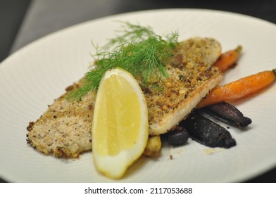 Crumbed Barramundi Fillet With Lemon Slice, Dill, And Rainbow Baby Carrots