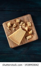 Crumbled Parmesan Cheese, Overhead Shot On A Dark Wooden Background With A Place For Text