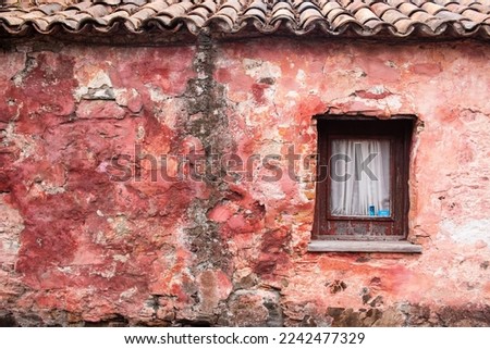 Crumbling pink house with small window, with space for copy
