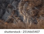 Crumbling steep mountainside. Strong erosion of rocks on mountain slopes. Sandy ravines on steep mountain slope. October, Crimea.