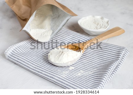 Crumbly xanthan gum in a wooden spoon. Natural thickening agent used in cooking.