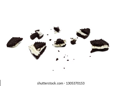 Crumbs Of Chocolate Sandwich Cookies  Filled With Cream Close-up Isolated On White Background.