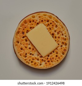 Crumpet With A Square Of Butter On Top.