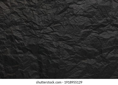 Crumpled Black Paper Texture Background.