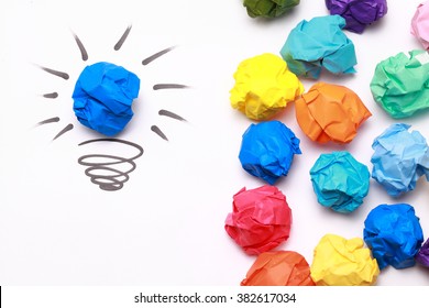 Crumpled Blue Paper Light Bulb Over White Background.