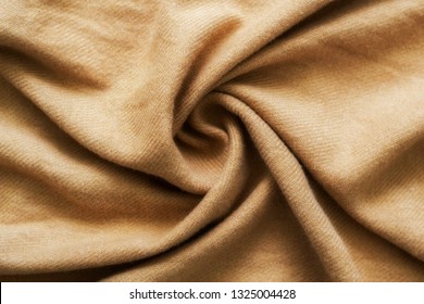Crumpled cashmere.Autumn background. Beautiful elegant brown scarf. Flat lay, top view