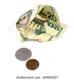 Crumpled dollars and small change on a white background