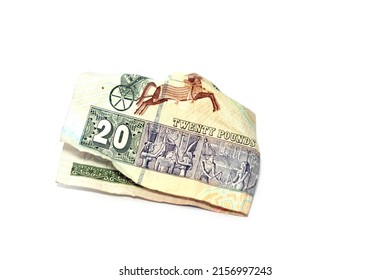 Crumpled Egyptian money of 20 LE twenty pounds isolated on white background, wrinkled 20 pounds cash bill banknote, Egypt money inflation and economy world crisis concept, selective focus