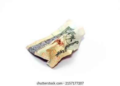Crumpled Egyptian money of 20 LE twenty pounds isolated on white background, wrinkled 20 pounds cash bill banknote, Egypt money inflation and economy world crisis concept, selective focus