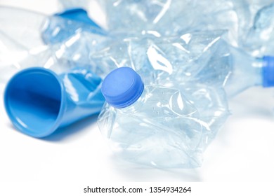 Crumpled empty single-use plastic cups and bottles, studio shot.  Plastic pollution concept. Single-use plastic is a human addiction that is destroying our planet  