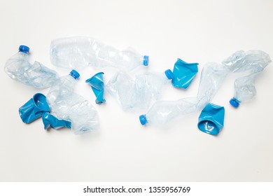 Crumpled empty single-use plastic cups and bottles, studio shot.  Plastic pollution concept. Single-use plastic is a human addiction that is destroying our planet.  