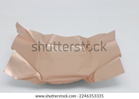 Crumpled golden wrapping paper with shiny effect. Abstract gold background