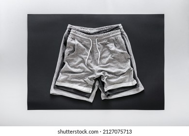 Crumpled Gray Black Shorts Pants For Man Sport. Set Various Of Basic Casual Clothing Sports Gray Male Shorts On White Black Frame Background. Minimalistic Basic Clothing Concept. Top View 