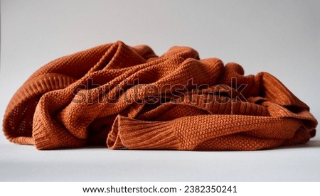 Crumpled up jumper on white background