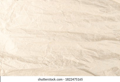 Crumpled Kraft Paper Texture Background. Wrinkled and Straightened Wrapping Paper Sheet Pattern, Wastepaper with Copy Space. Creased Page Wallpaper