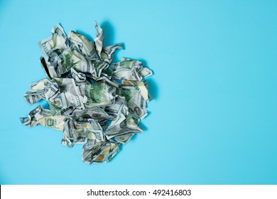 Crumpled Money On A Blue Background