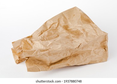 Crumpled Paper Bag With Greasy Spots On A White Isolated Background. Recycling Of Secondary Waste.