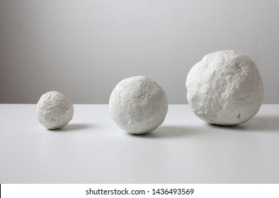 Crumpled Paper Ball On White. White Balls Of Papier Mache, Similar To The Planet. Fantasy Paper Balls. Lightweight Textural Balls.