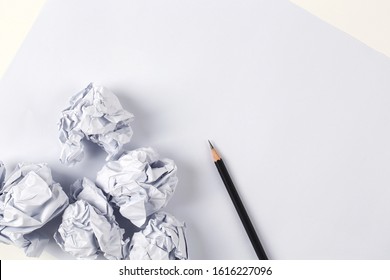 Crumpled Paper And Pencil Over Blank White Sheet