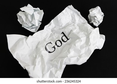 Crumpled Paper Sheet With Word God Isolated On Black