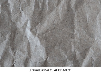 Crumpled paper texture. Wrinkled recycled brown wrapping paper background. Grunge backdrop.