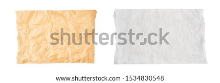 Crumpled piece of brown and white parchment or baking paper isolated on white background. Top view. Copy space for text. Design element.