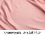 Crumpled pink silk fabric as background, top view. Space for text