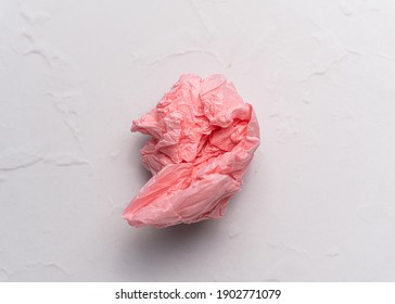 Crumpled Pink Tissue Paper Ball On White Background