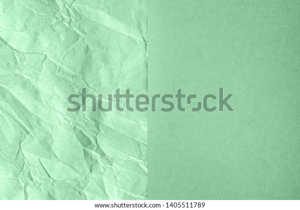 Crumpled and plain paper sheets\
divided in center creating line partition. Trendy green ash colored\
abstract background design. Flat lay. Color of the year\
2021