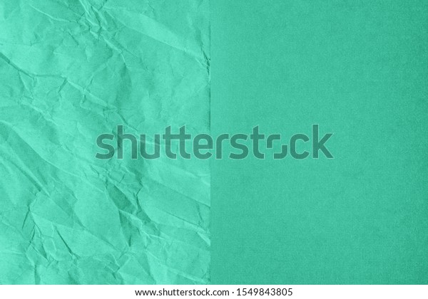 Crumpled and plain paper\
sheets divided in center creating line partition. Trendy mint\
colored abstract background design. Flat lay, copy space. Year\
color concept.