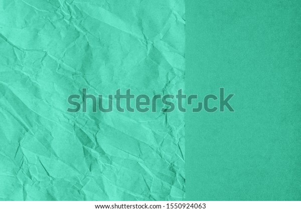 Crumpled and plain paper sheets divided\
creating line partition. Trendy mint colored abstract background\
design. Flat lay, copy space. Year color\
concept.