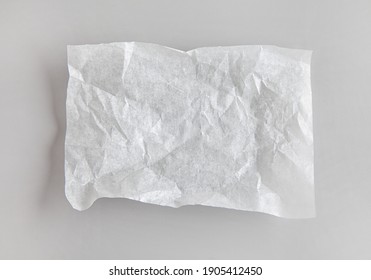 Crumpled Sheet Of White Baking Paper On Grey Kitchen Table, Top View