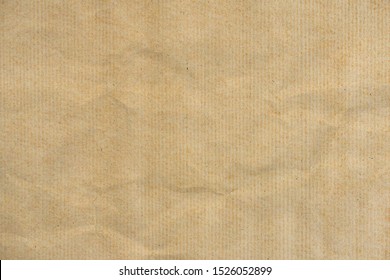 Crumpled and stains of striped kraft paper texture background. Crumpled brown striped paper