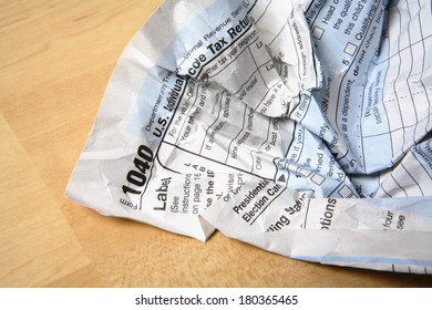 Crumpled Tax Form Paperwork On Wood Table