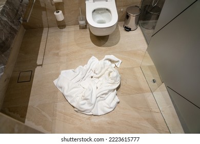 Crumpled Used Towel On The Bathroom Floor