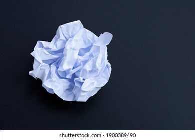 Crumpled White Paper Ball On Dark Background. Copy Space