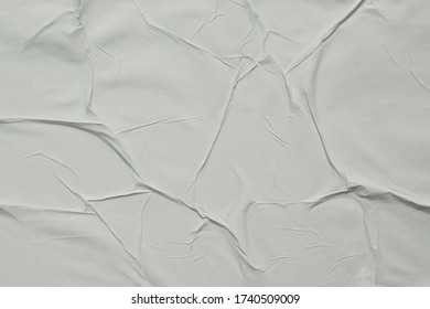 Crumpled White Paper Glued On The Wall. Pleated Paper Close Up.