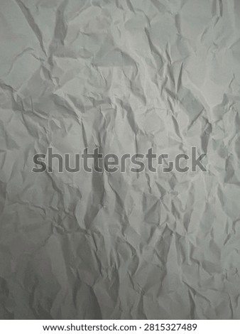 Crumpled white paper texture background, abstract creased sheet close-up.