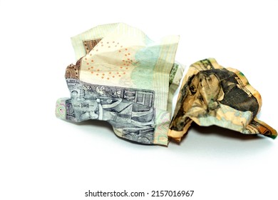 Crumpled  wrinkled American money note of 20 $ twenty dollars bill and 20 LE twenty Egyptian pounds cash banknote isolated on white background, economy inflation and world money crisis concept