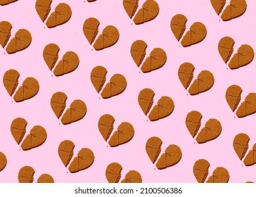 Crunch heart shaped cookie broken heart on pastel pink background seamless isometric pattern. Disappointed parting love divorce minimal concept.