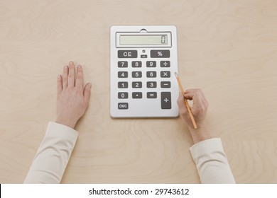 Crunching Numbers - Overhead Shot Of Hands Using Calculator