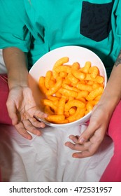 Crunchy Cheese Snacks In The Basket In The Hands Of Women.