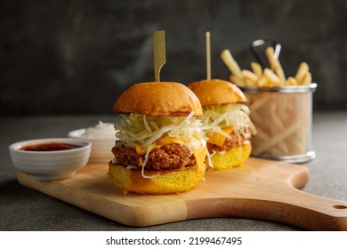 crunchy chicken slider sandwich burger with fries isolated on cutting board side view of fastfood - Powered by Shutterstock