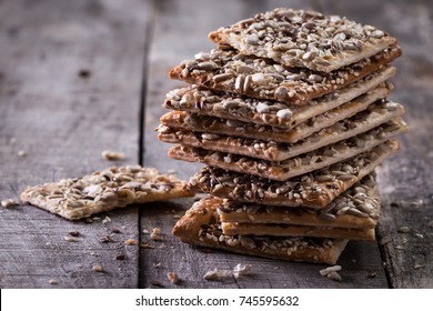 Crunchy crispbread on a wooden background. Healthy snack: cereal crunchy multigrain cereal flax seed ,sesame, sunflower seeds protein bread bar.