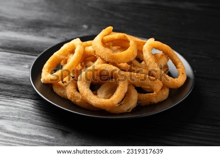 Crunchy Fried Battered onion rings on black plate